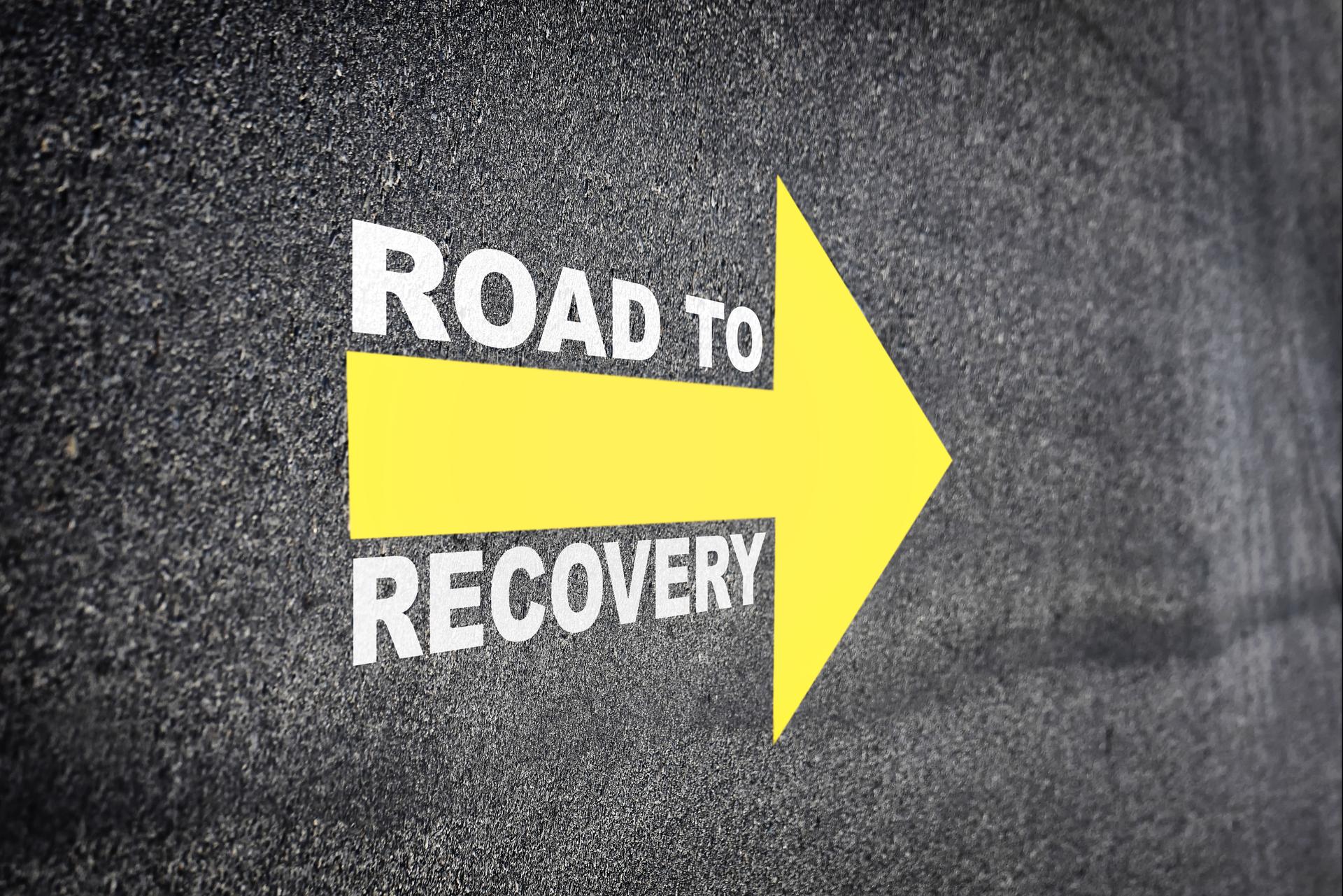 Recovery written with yellow arrow on road