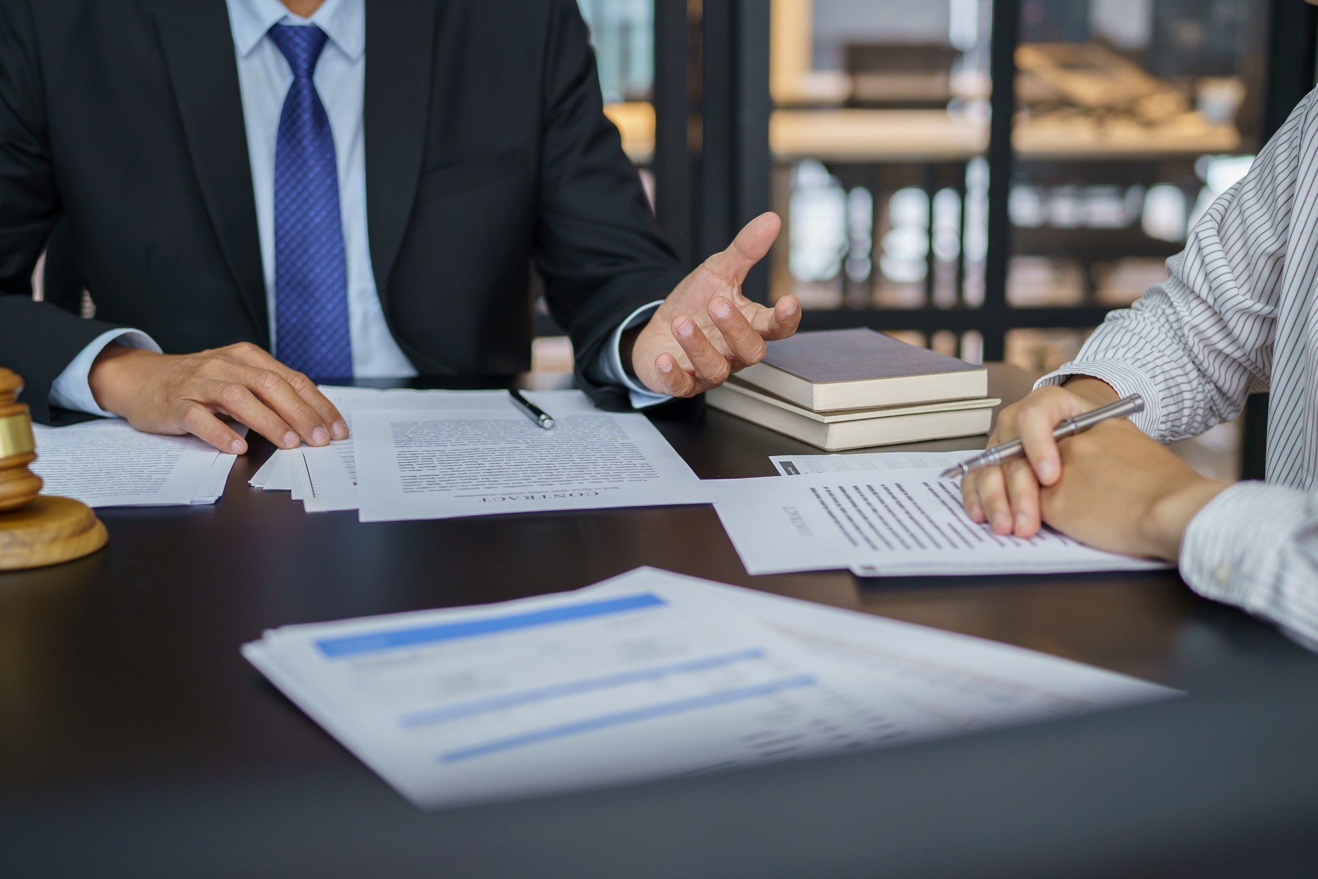 Lawyer Legal counsel presents to the client a signed contract with gavel and legal law. justice and lawyer Business partnership meeting concept.